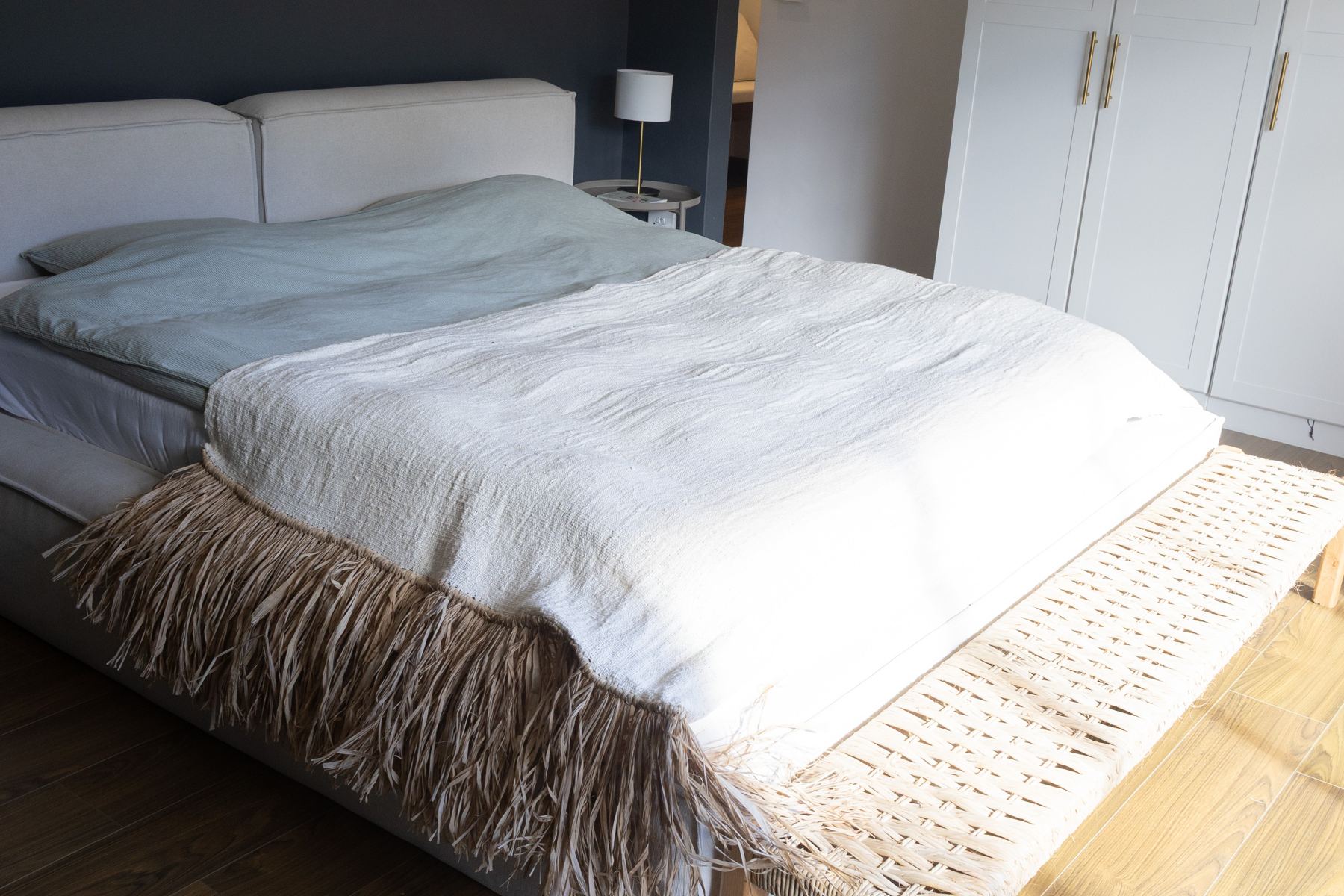 Main bedroom with a raffia trimmed bed