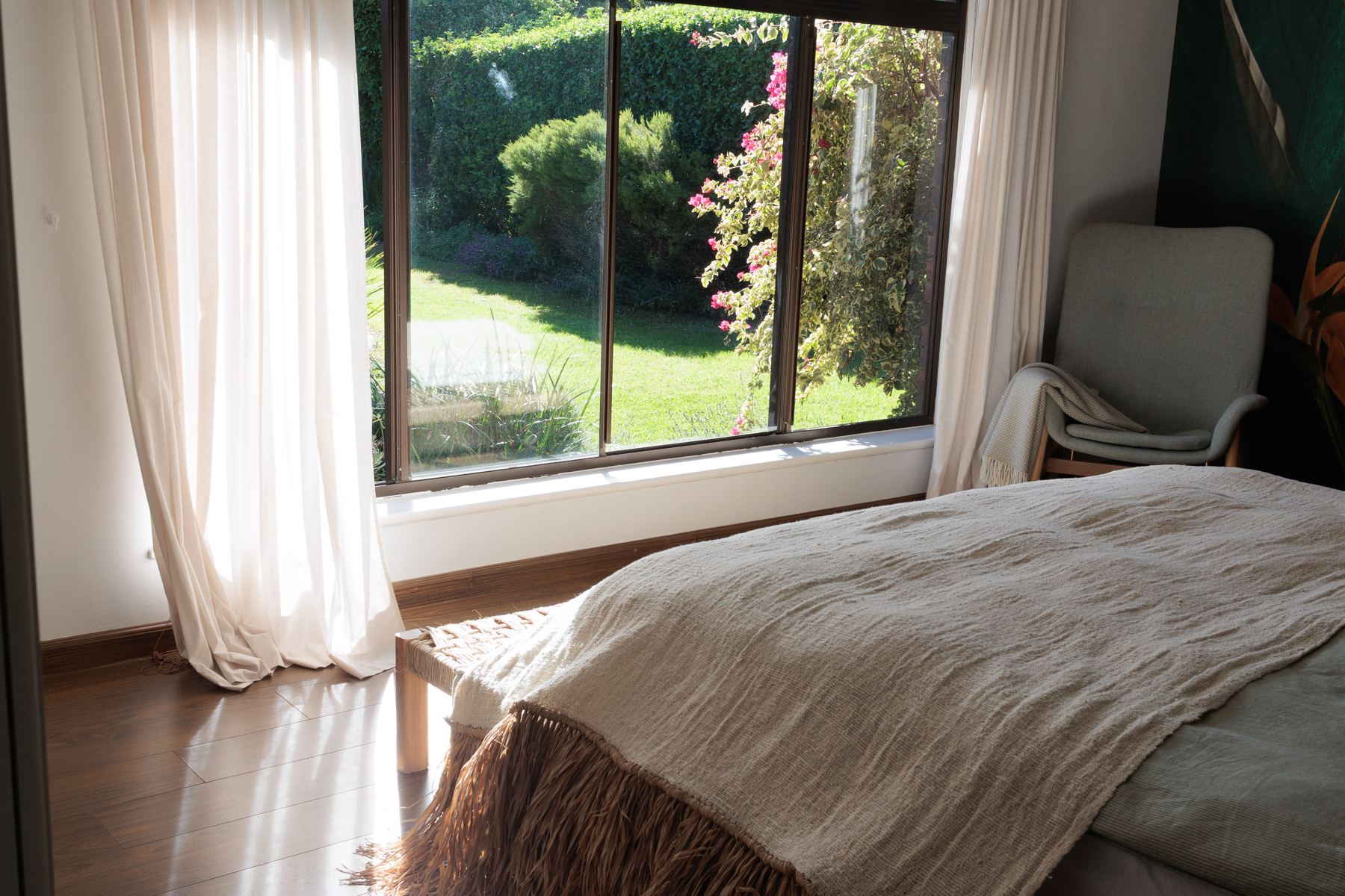 Main bedroom with garden views through a large window