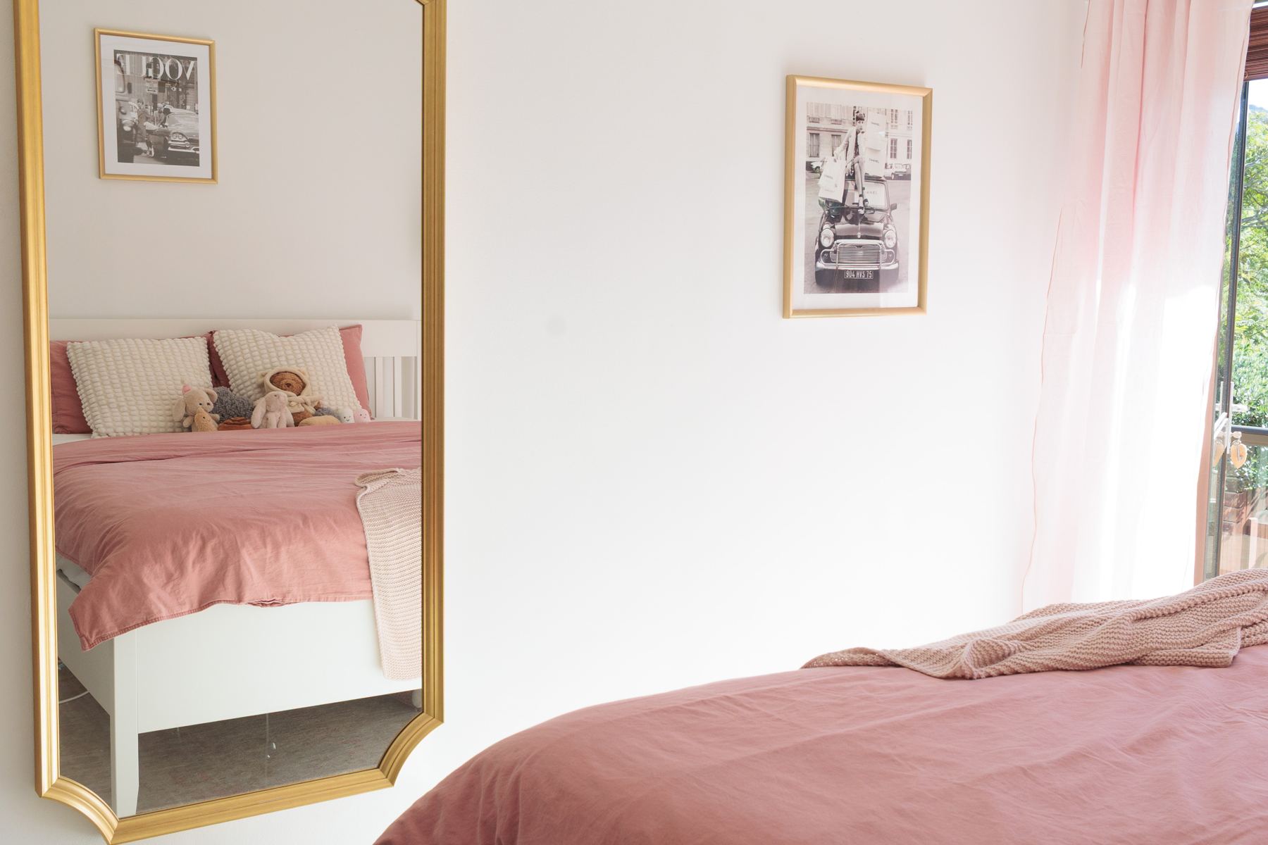 Upstairs bedroom with a gold framed mirror