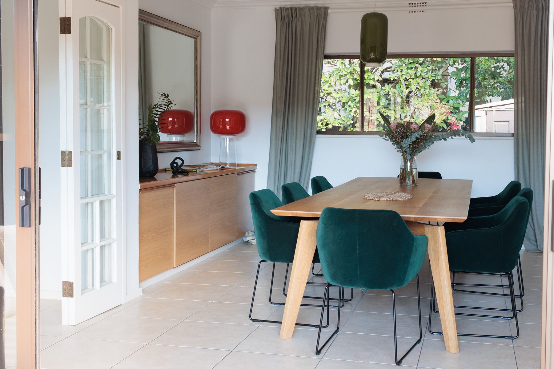 Dining room with a timber table and green chairs