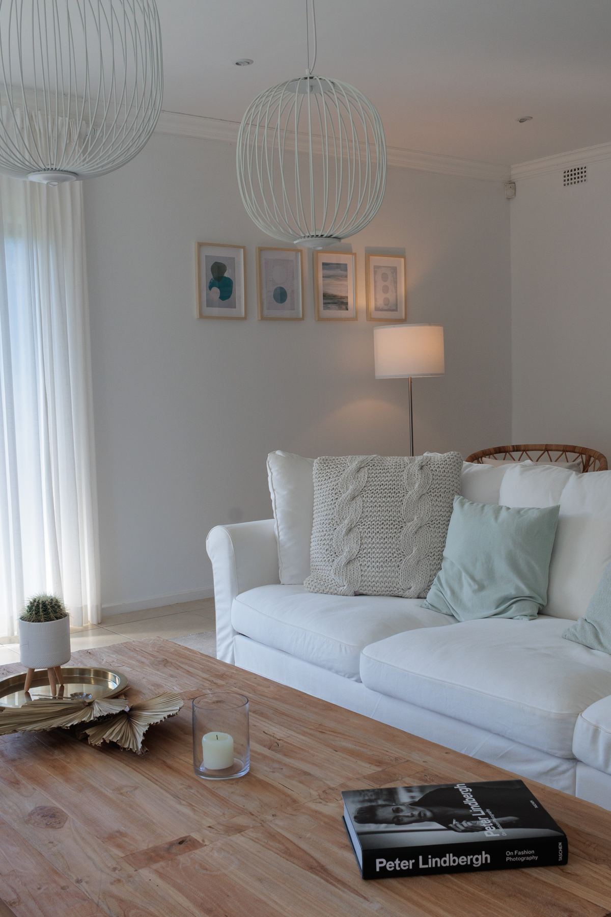 White sofa beside a floor lamp and coffee table
