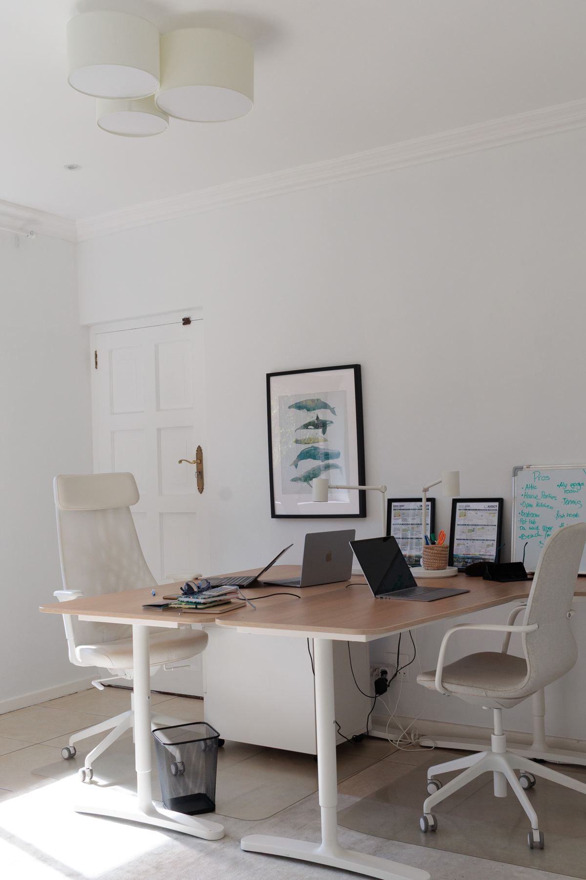 Office desk with two chairs and framed art