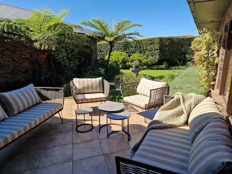 Patio lounge surrounded by greenery